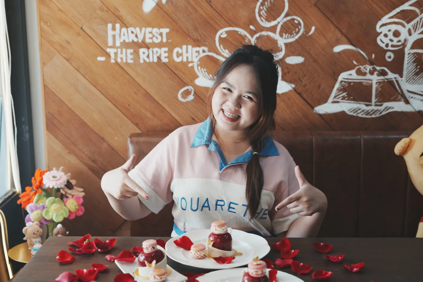 A student smiling beside the desserts she made in class.