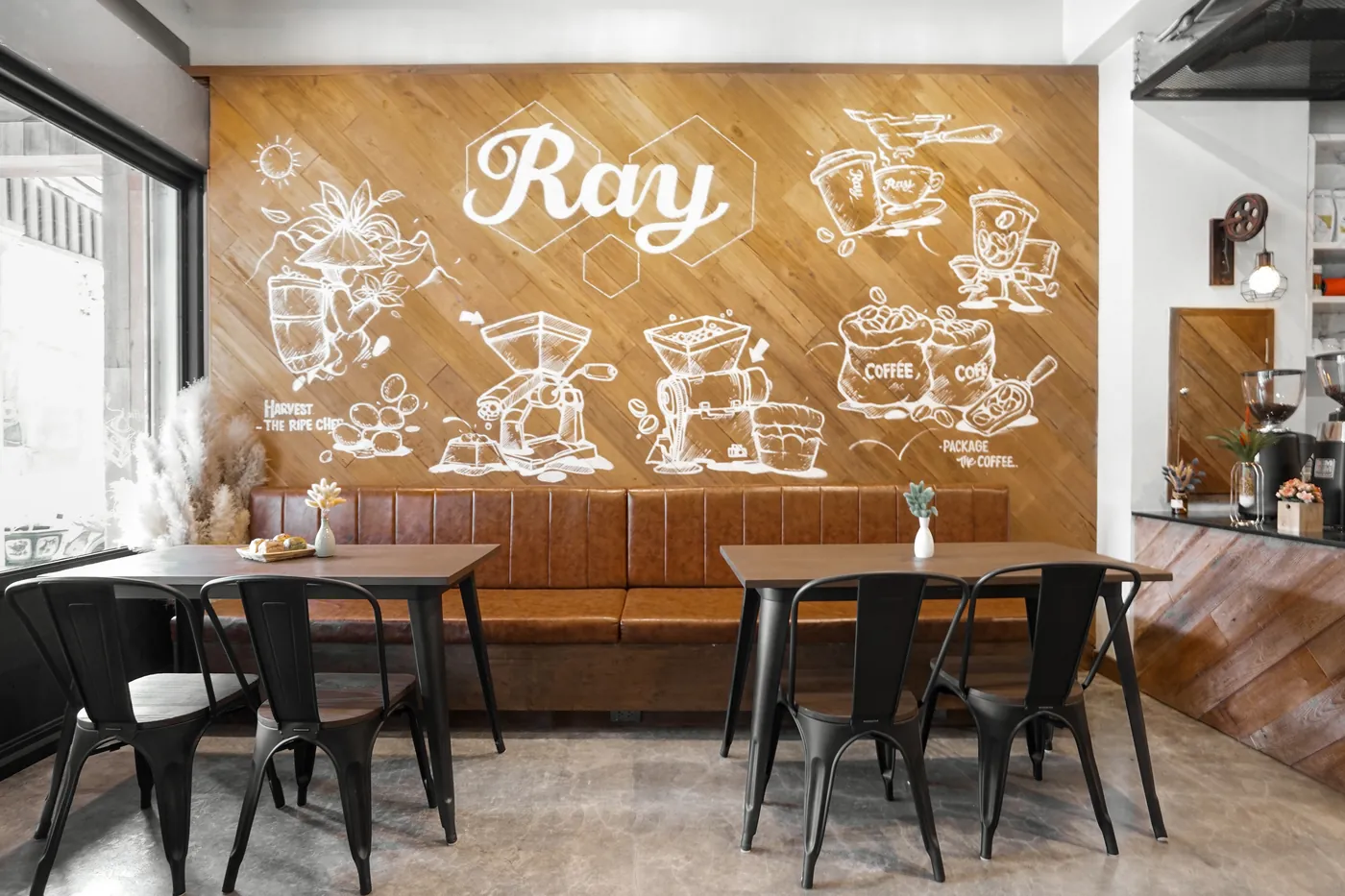 The coffee bar's tables under the Ray mural.