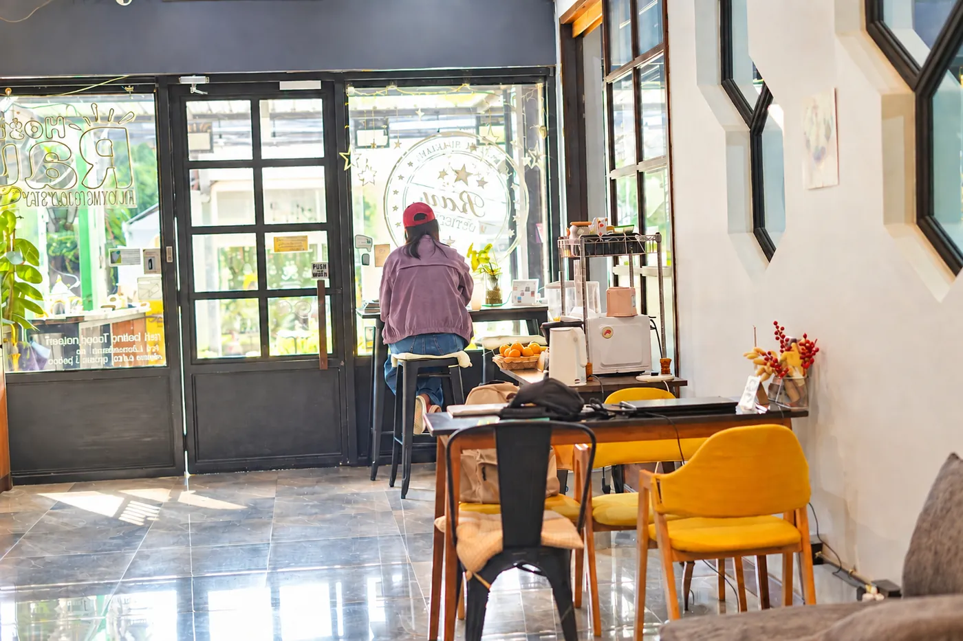A guest at the window counter of the coffee bar.