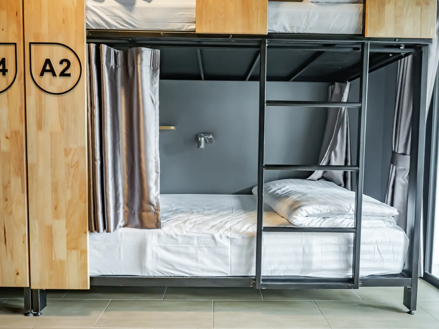 Bed A2 with its curtain open and its reading light.