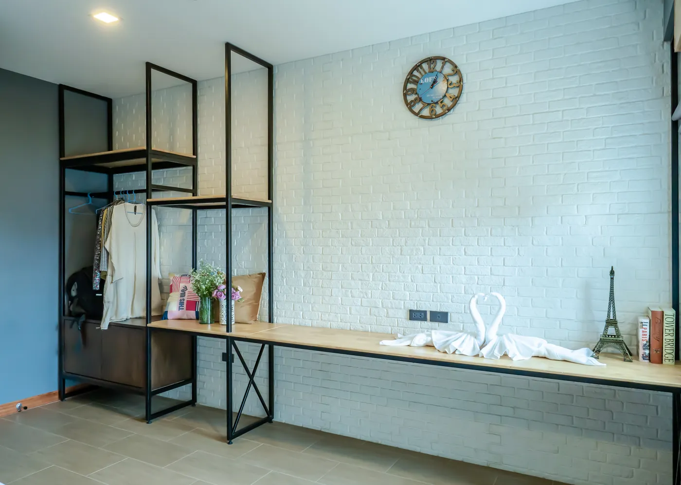 The long desk and clothes rail along the family room's brick wall.
