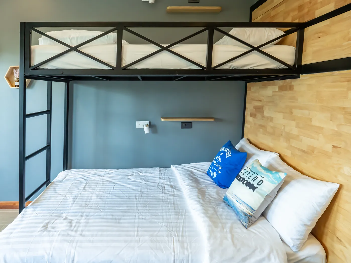 The double bed with its pillows, under the bunk.